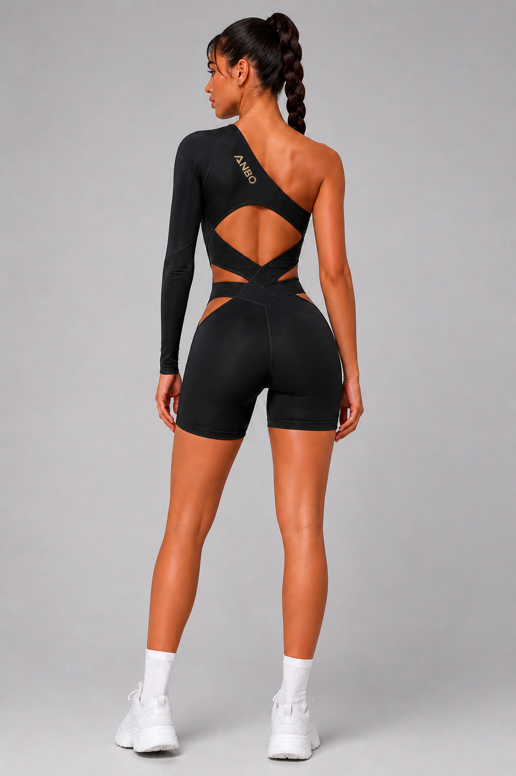 Studio photograph — ANBO asymmetric bodysuit with architectural back cutouts